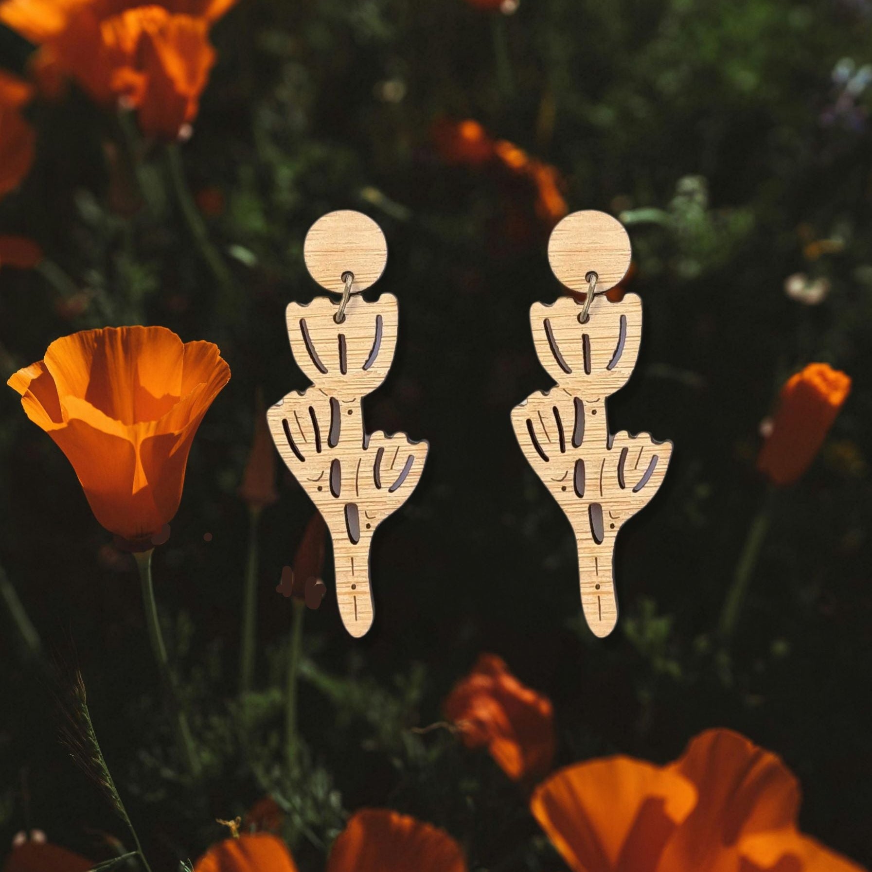 laser cut poppy dangles earring s on a photo of a california poppy field