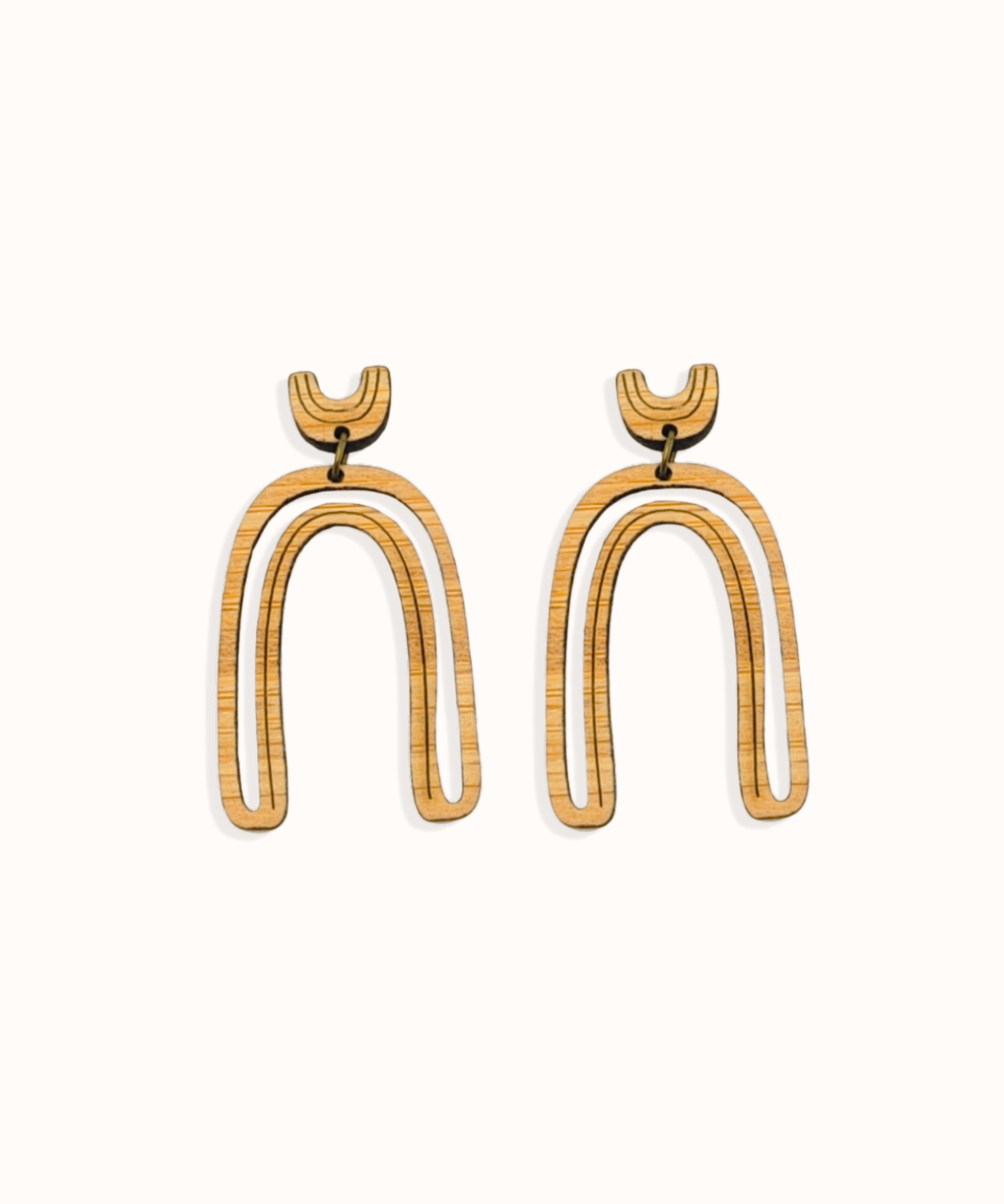 Arch shape delicate cut-out earrings on white background