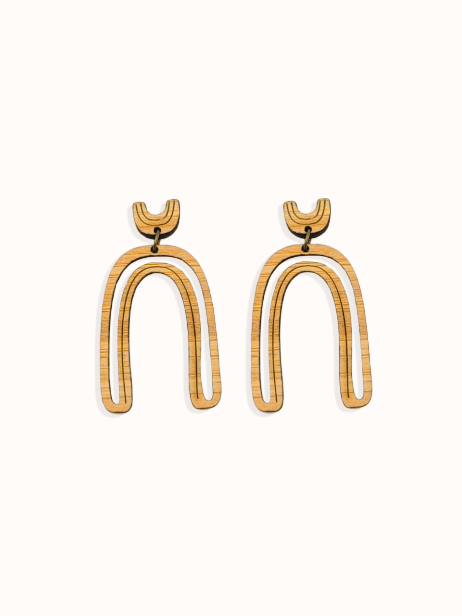 Arch shape delicate cut-out earrings on white background