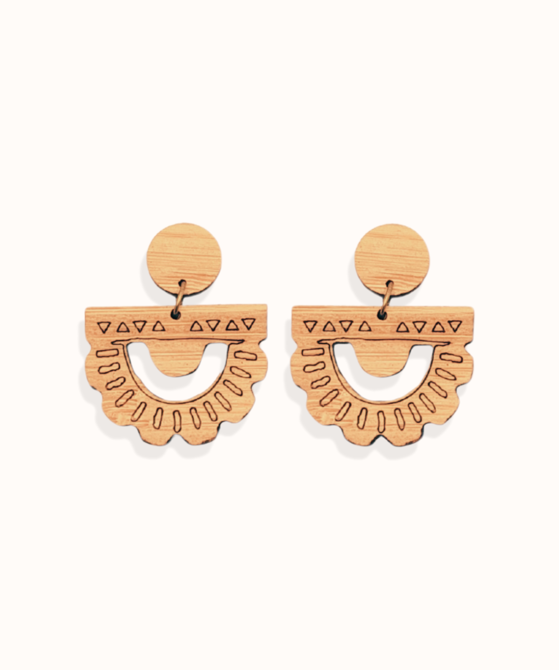 ethically made wooden earrings with sunset inspired designs engrave on them on a white background