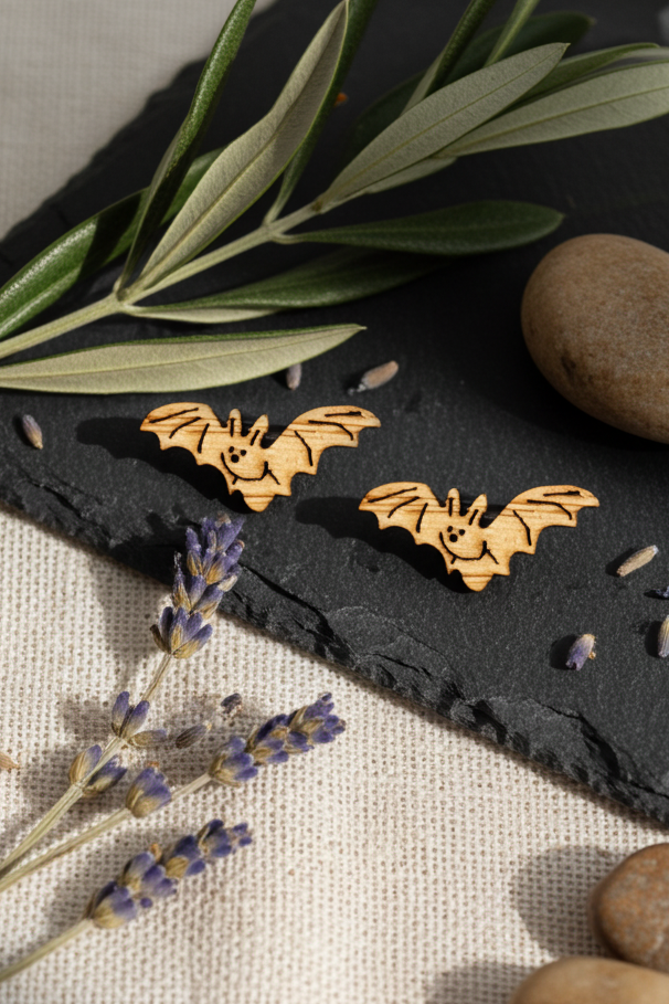 bat stud earring on a black slate with lavender