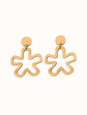 Wooden minimalist daisy shaped earrings on a white background