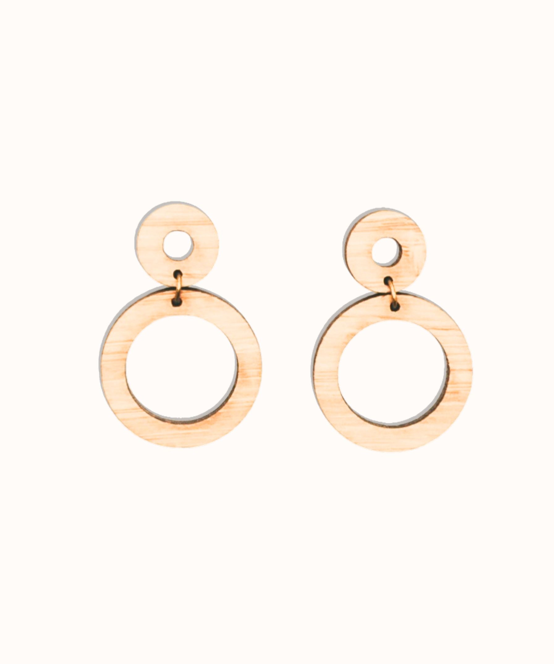 Pair of handmade bamboo wooden hoop earrings on a white background