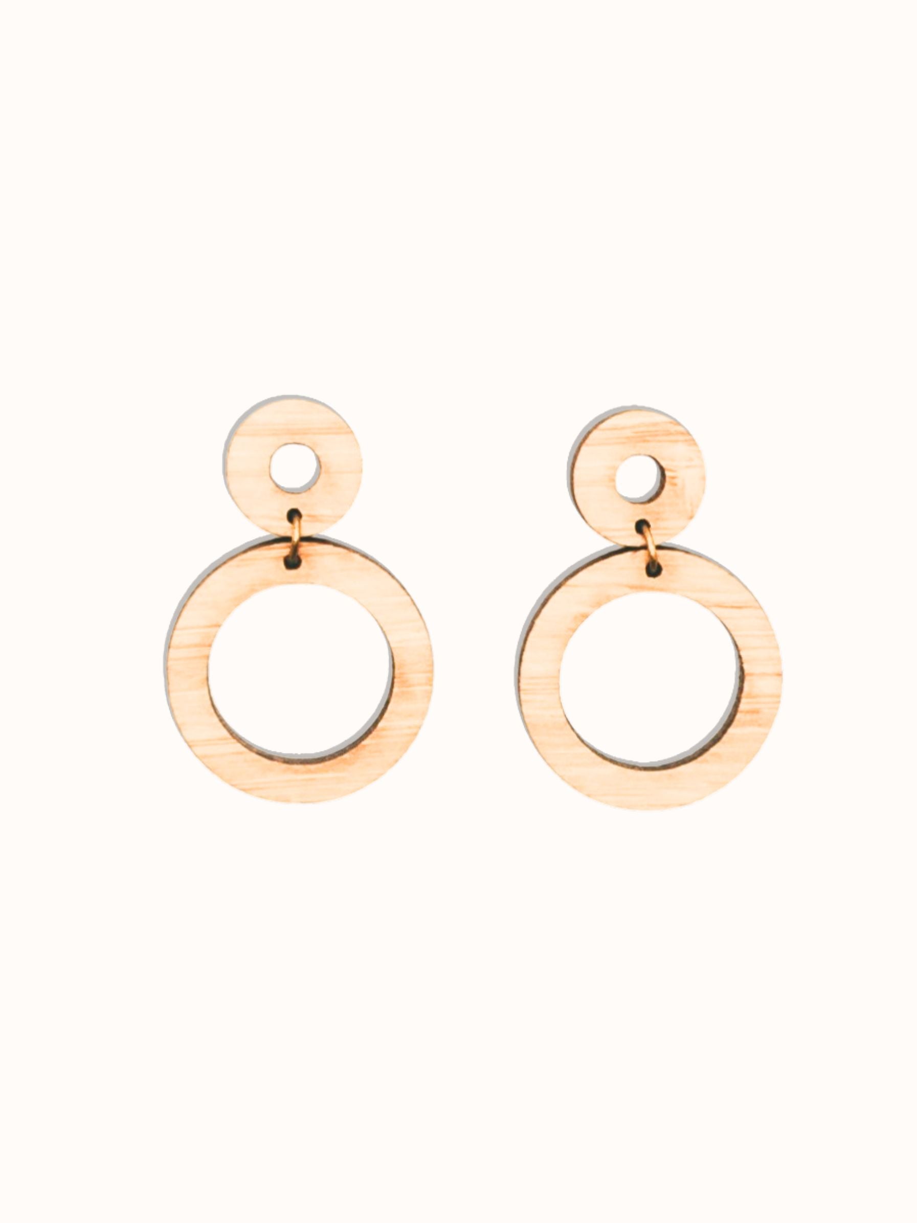 Pair of handmade bamboo wooden hoop earrings on a white background