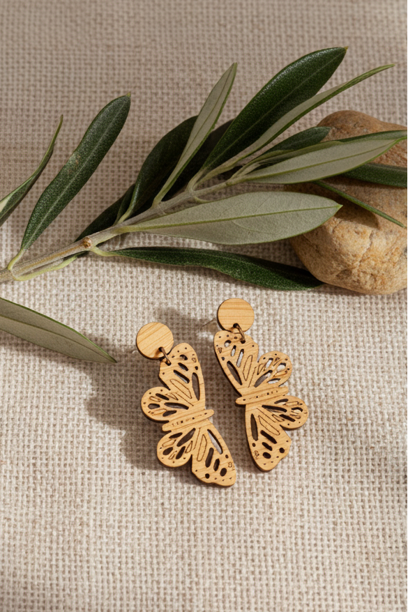 monarch dangles wood earrings on linen background