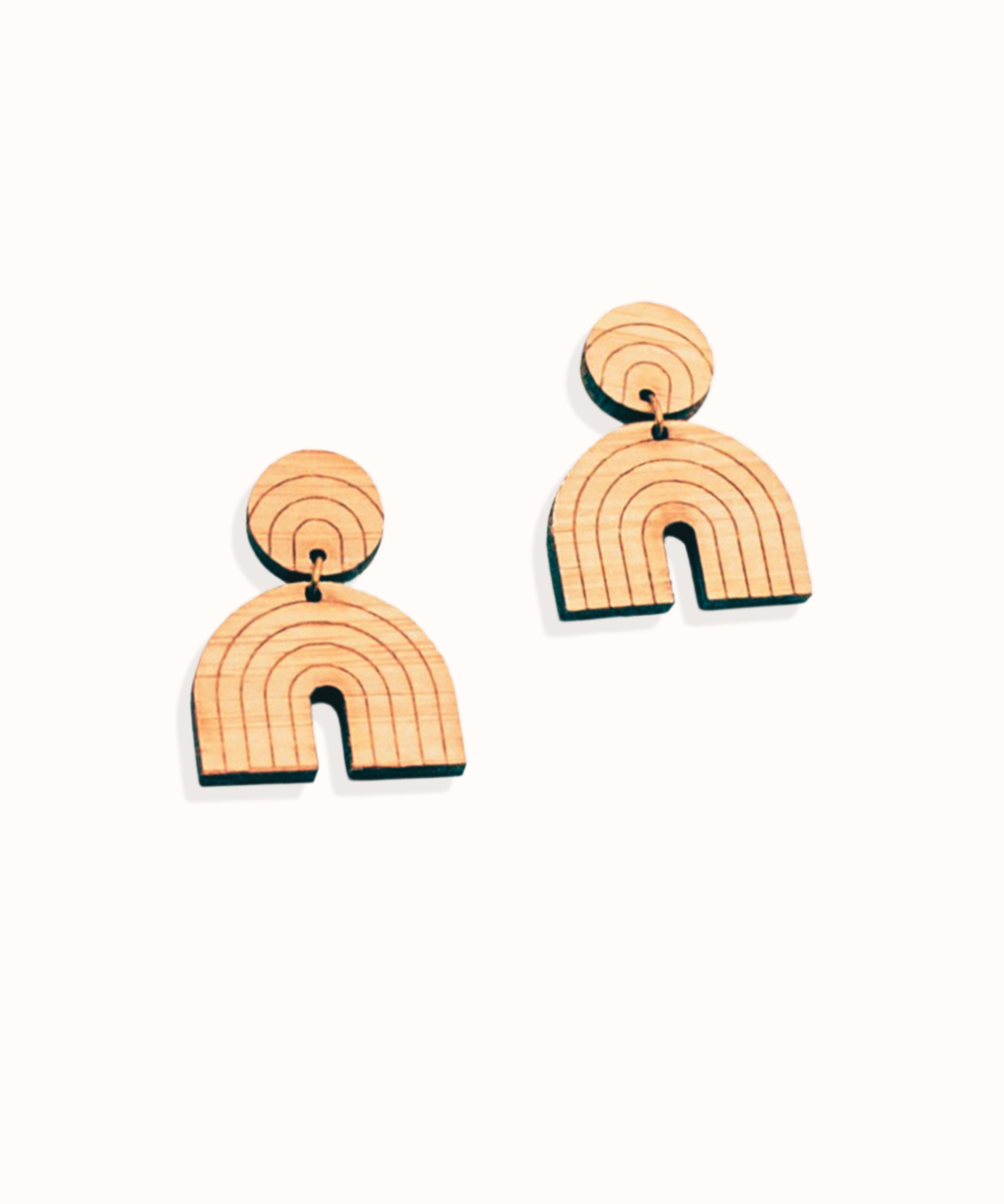 Pair of rainbow-shaped dangle wood earrings on a white background
