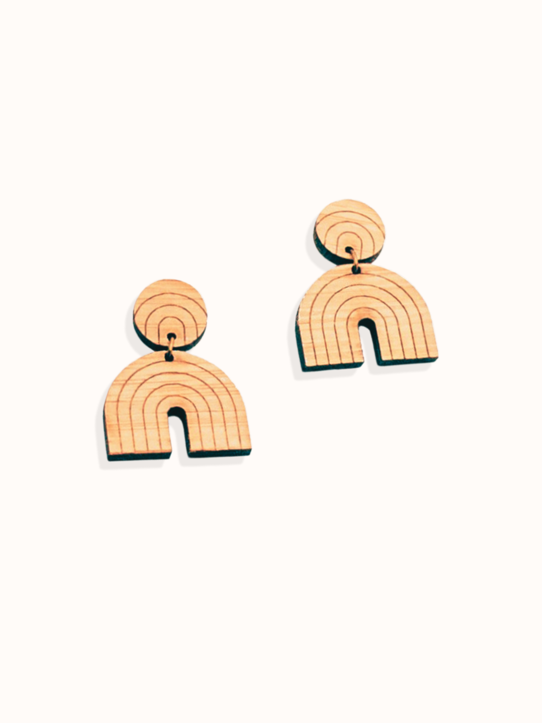Pair of rainbow-shaped dangle wood earrings on a white background