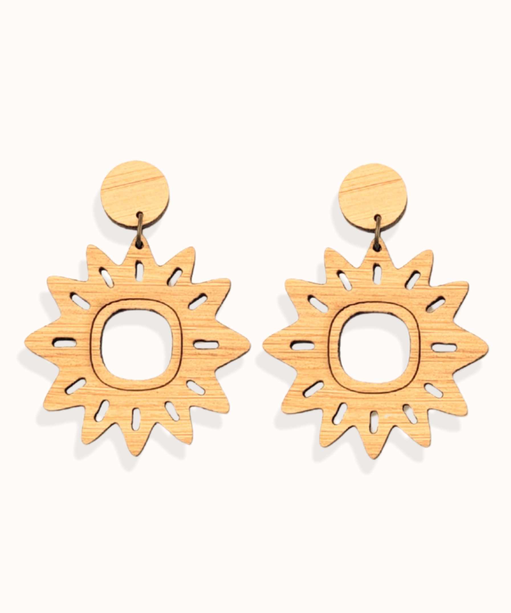 Pair of sun-shaped lightweight dangle earrings on a white background