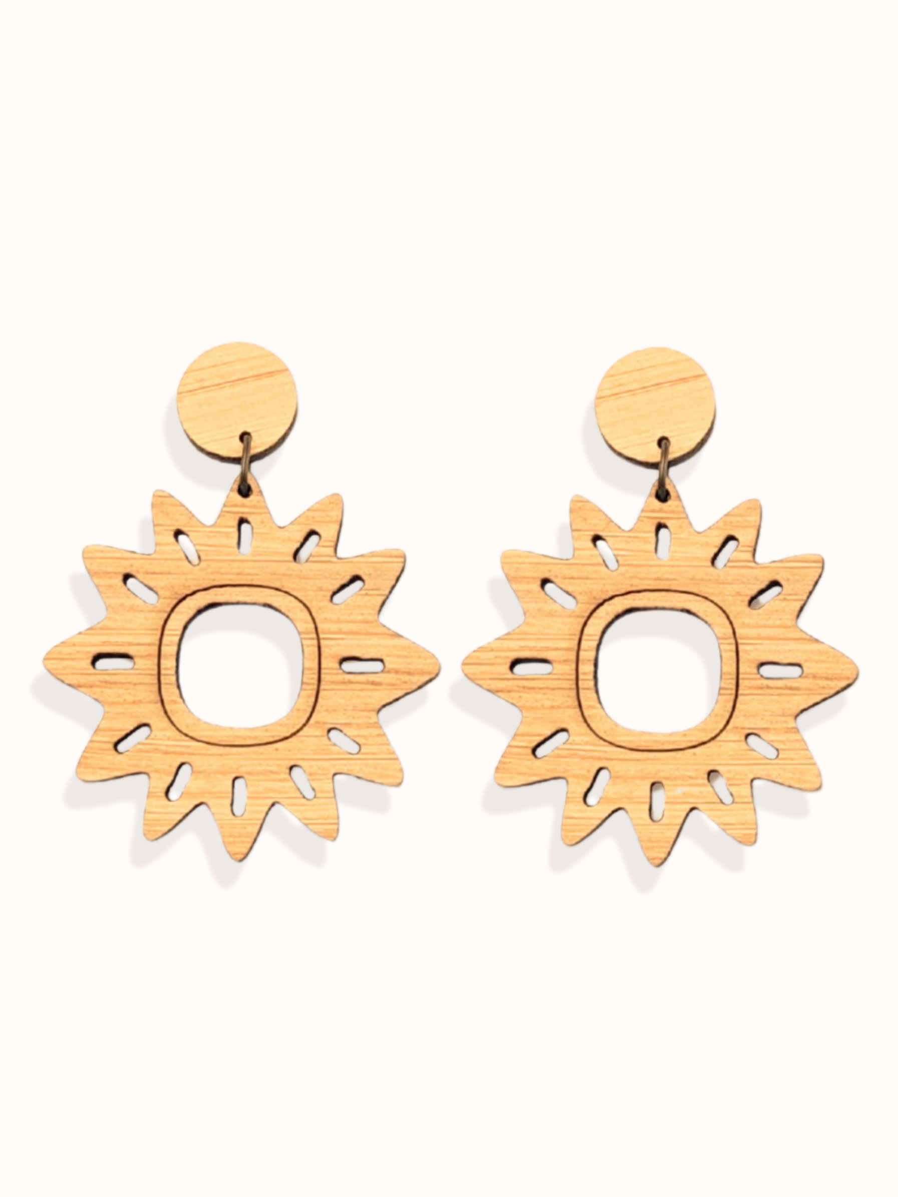 Pair of sun-shaped lightweight dangle earrings on a white background