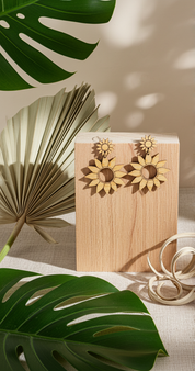 sunflower dangle earring hang on a block of wood with tropical leaves around